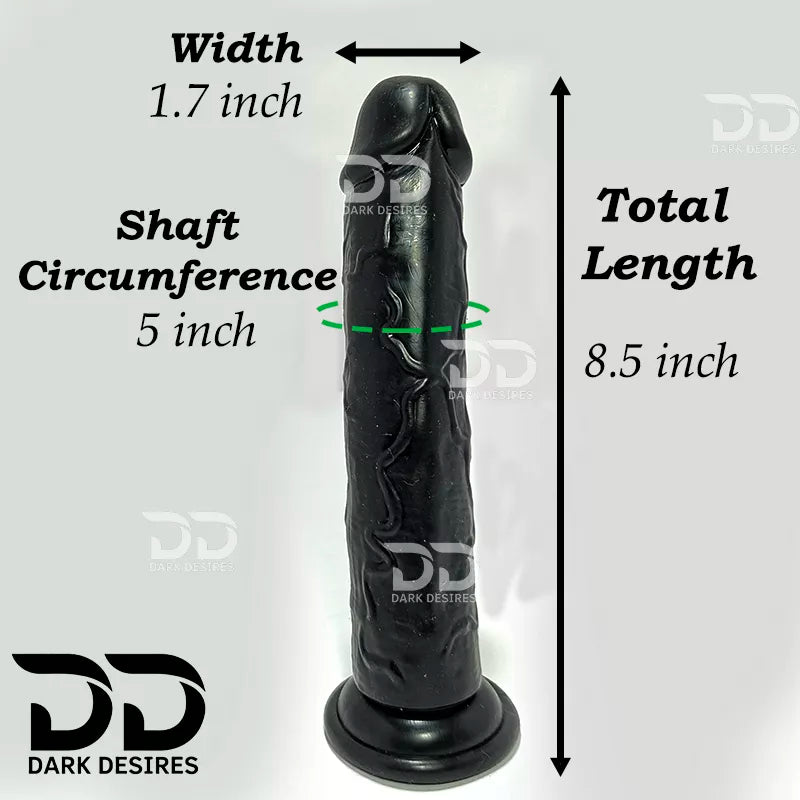 Black realistic dildo shown with overlaid dimension arrows and text indicating width 1.7 inch, shaft circumference 5 inch, and total length 9 inch . 9 inch realistic strapon dildo with adjustable harness kit for for pegging . Lifelike veins, black tone, soft glans. Black faux leather belt Sex Toys for Women in Mumbai India by DarkDesires