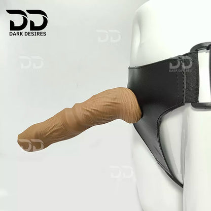 7.5 inch strap-on dildo with balls in a natural brown tone, with detailed veins along the shaft and a realistic tip. It has a 6 inch insertable length and a 5 inch girth. buy strapon dildo online in India with a harness included at DarkDesires