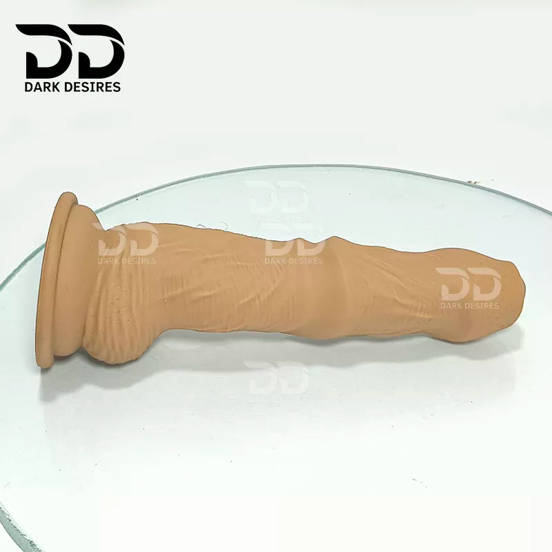 7.5 inch dildo with balls in a natural brown tone, with detailed veins along the shaft and a realistic tip. It has a 6 inch insertable length and a 5 inch girth. buy dildo online in India at DarkDesires