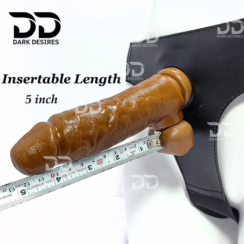 Brown textured realistic dildo shown  with a black harness, overlaid text reading 'Insertable Length 5 inch' and a measuring tape along the shaft. A realistic chocolate brown-toned dildo with a black harness-style base Black faux leather harness with an adjustable strap and a skin tone realistic dildo protruding from the front, displayed 7 inch realistic strapon dildo with adjustable harness kit for  for pegging . Lifelike veins, sculpted balls, chocolate brown tone, soft glans.  Black faux leather belt Sex