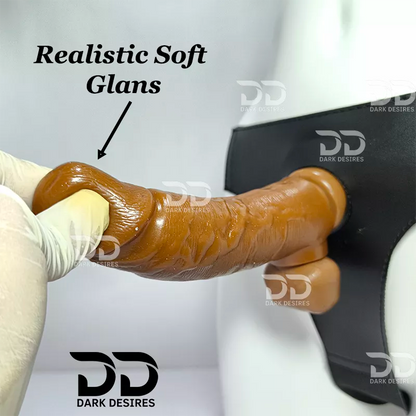 A realistic soft glans dildo shown being held by a gloved hand, A realistic chocolate brown-toned dildo with a black harness-style base Black faux leather harness with an adjustable strap and a skin tone realistic dildo protruding from the front, displayed 7 inch realistic strapon dildo with adjustable harness kit for  for pegging . Lifelike veins, sculpted balls, chocolate brown tone, soft glans.  Black faux leather belt Sex Toys for Women in Mumbai India by DarkDesires