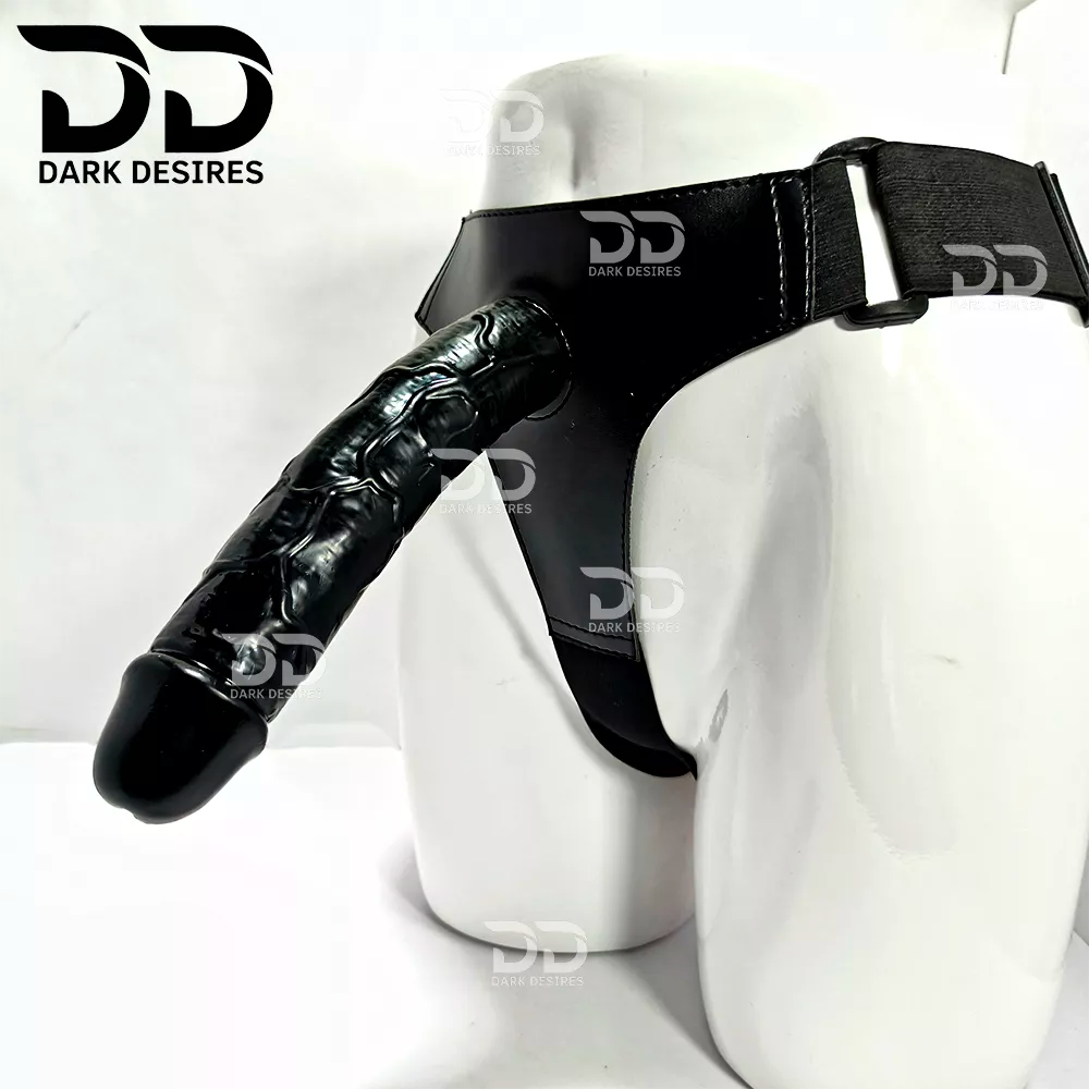 A realistic black-toned dildo with a black harness-style base Black faux leather harness with an adjustable strap and a black tone realistic dildo displayed 9 inch realistic strapon dildo with adjustable harness kit for  for pegging . Lifelike veins, black tone, soft glans.  Black faux leather belt Sex Toys for Women in Mumbai India by DarkDesires