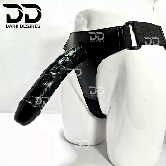 A realistic black-toned dildo with a black harness-style base Black faux leather harness with an adjustable strap and a black tone realistic dildo displayed 9 inch realistic strapon dildo with adjustable harness kit for  for pegging . Lifelike veins, black tone, soft glans.  Black faux leather belt Sex Toys for Women in Mumbai India by DarkDesires