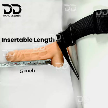 A beige flesh-toned insertable dildo shown wrapped around a white cylindrical form with a black strap, alongside a metal tape measure labeled 5 inch and the text 'Insertable Length.' hollow strapon  dildo penis sleeve extender. Adds girth and length, works pre and post-erection, harness compatible dark chocolate flesh tone color Buy Hollow Strapon dildo in India byDarkDesires